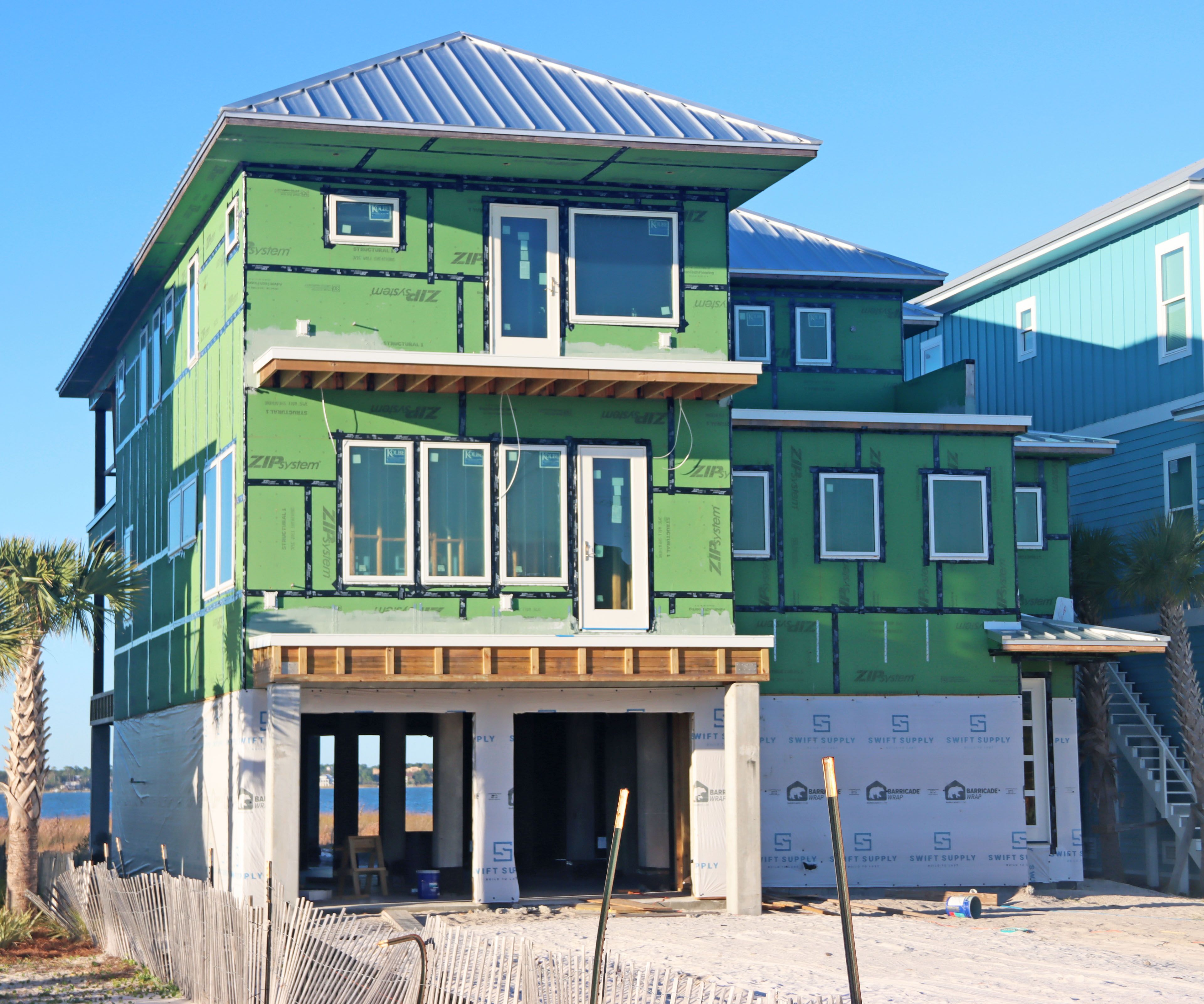 Modern coastal piling home in Navarre by Acorn Fine Homes