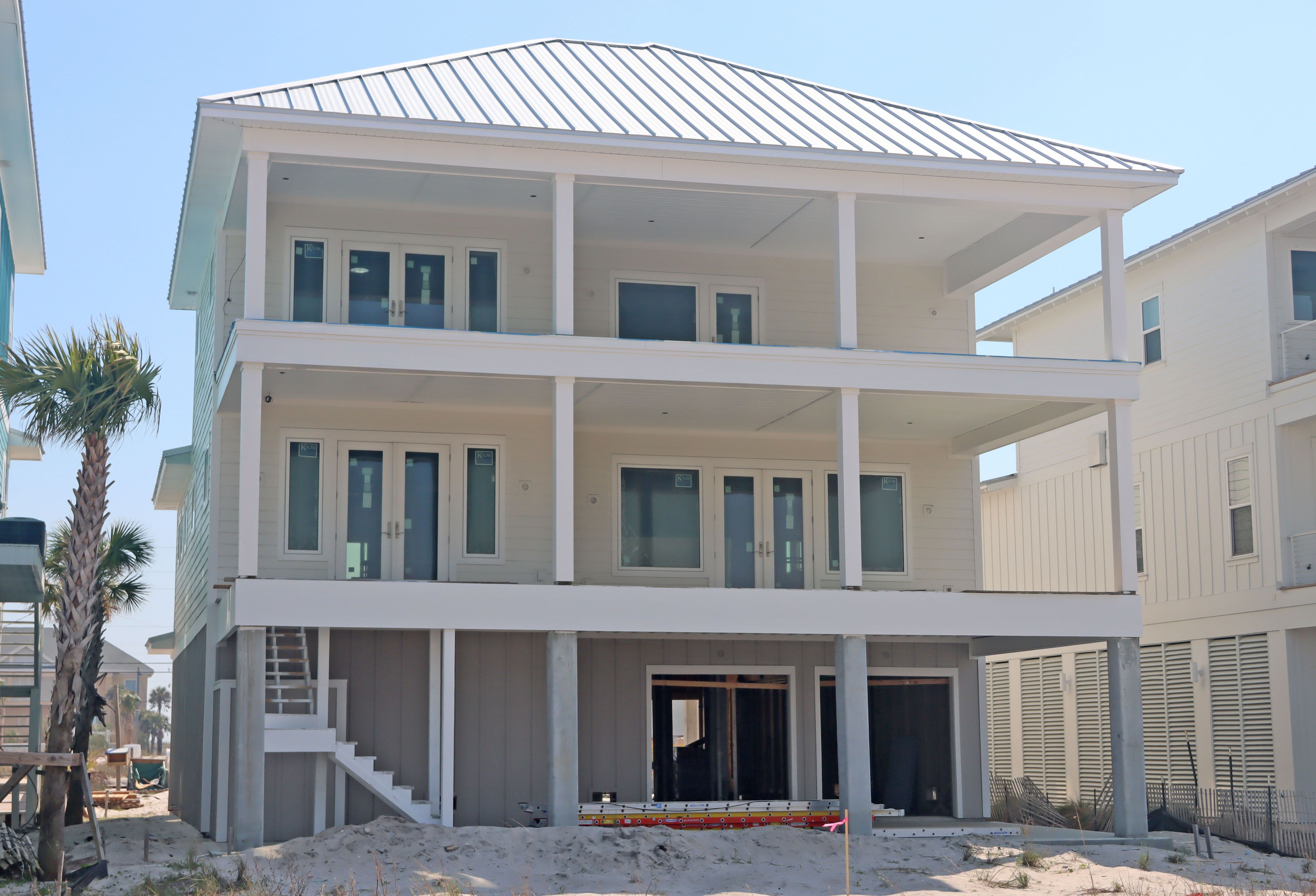 Modern coastal piling home in Navarre by Acorn Fine Homes