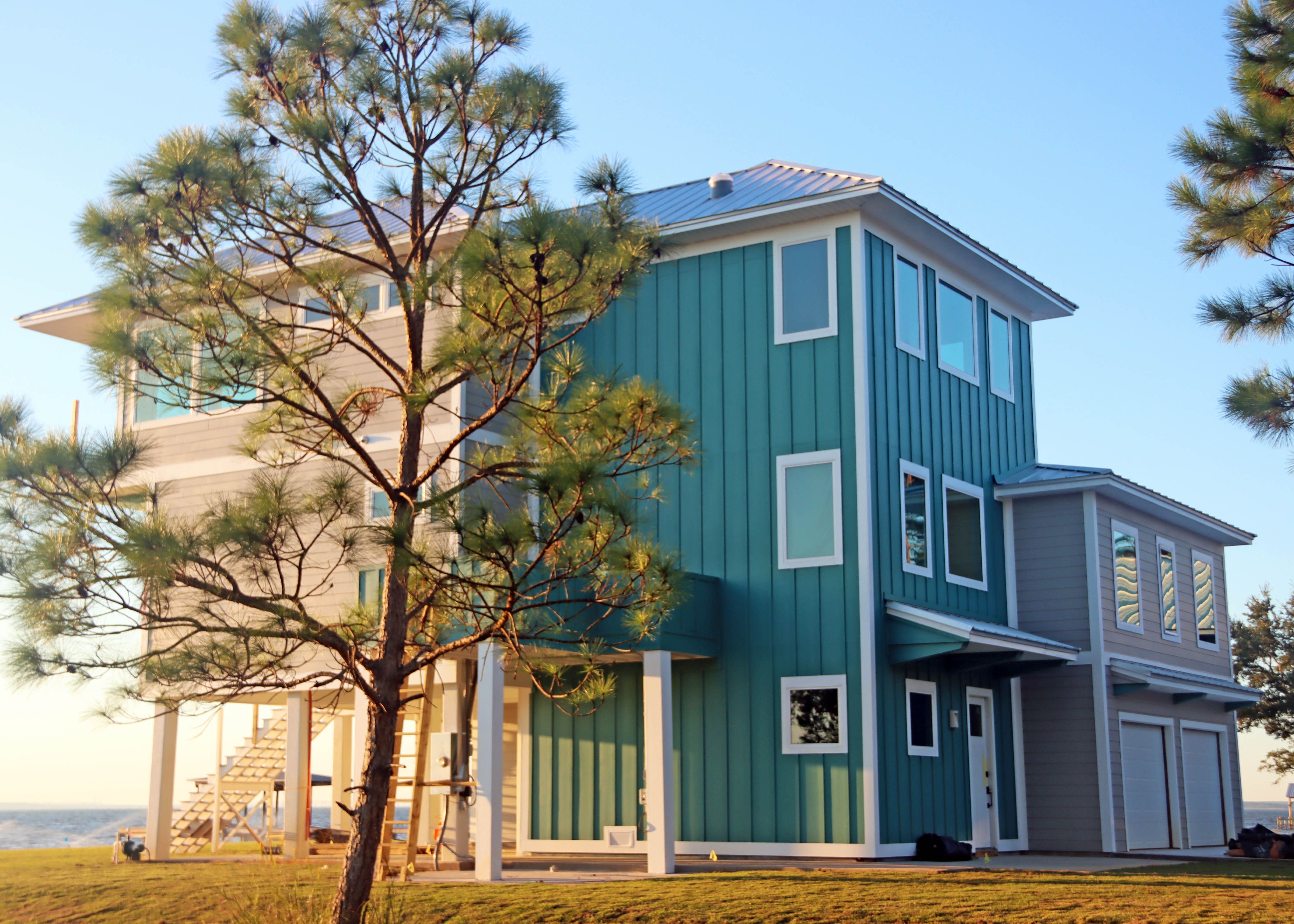 Modern piling home in Navarre, Gulf Breeze, Milton by Acorn Fine Homes