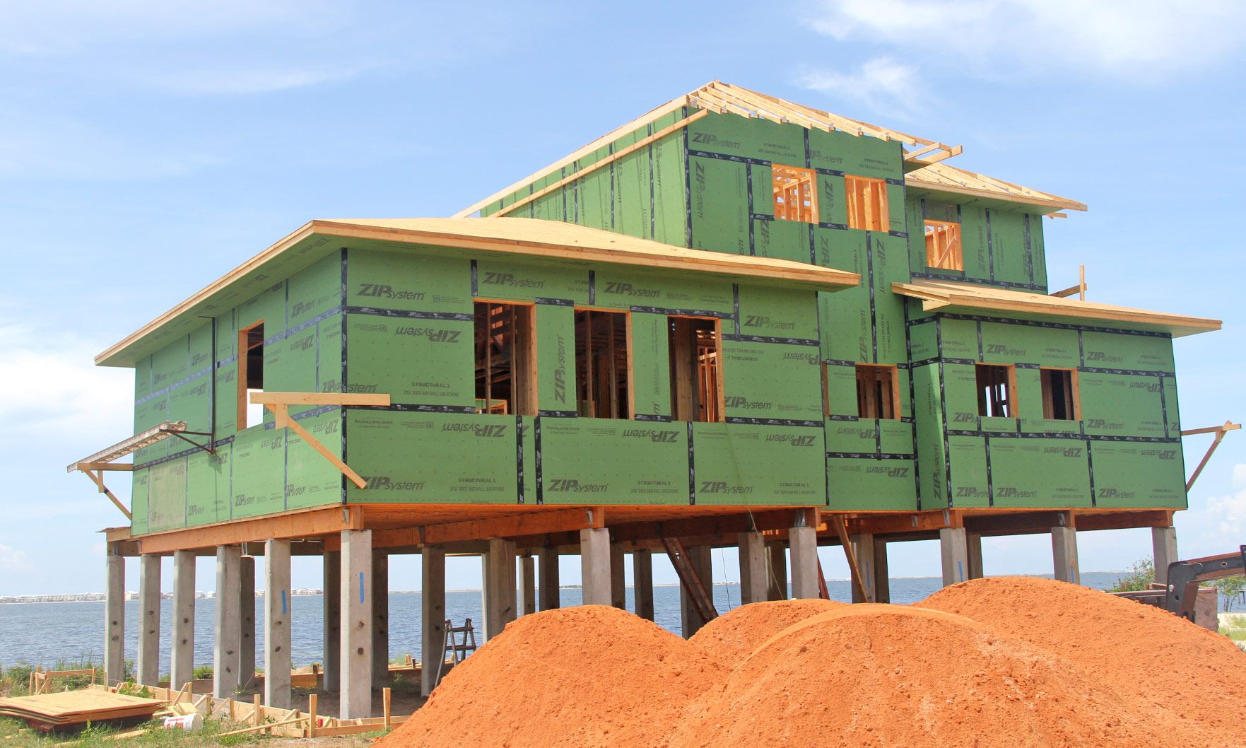 Moreland modern piling home on Navarre Beach by Acorn Fine Homes