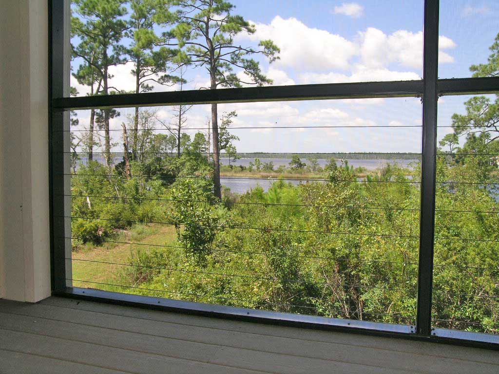 Wire rope railing in screen porch by Acorn Construction