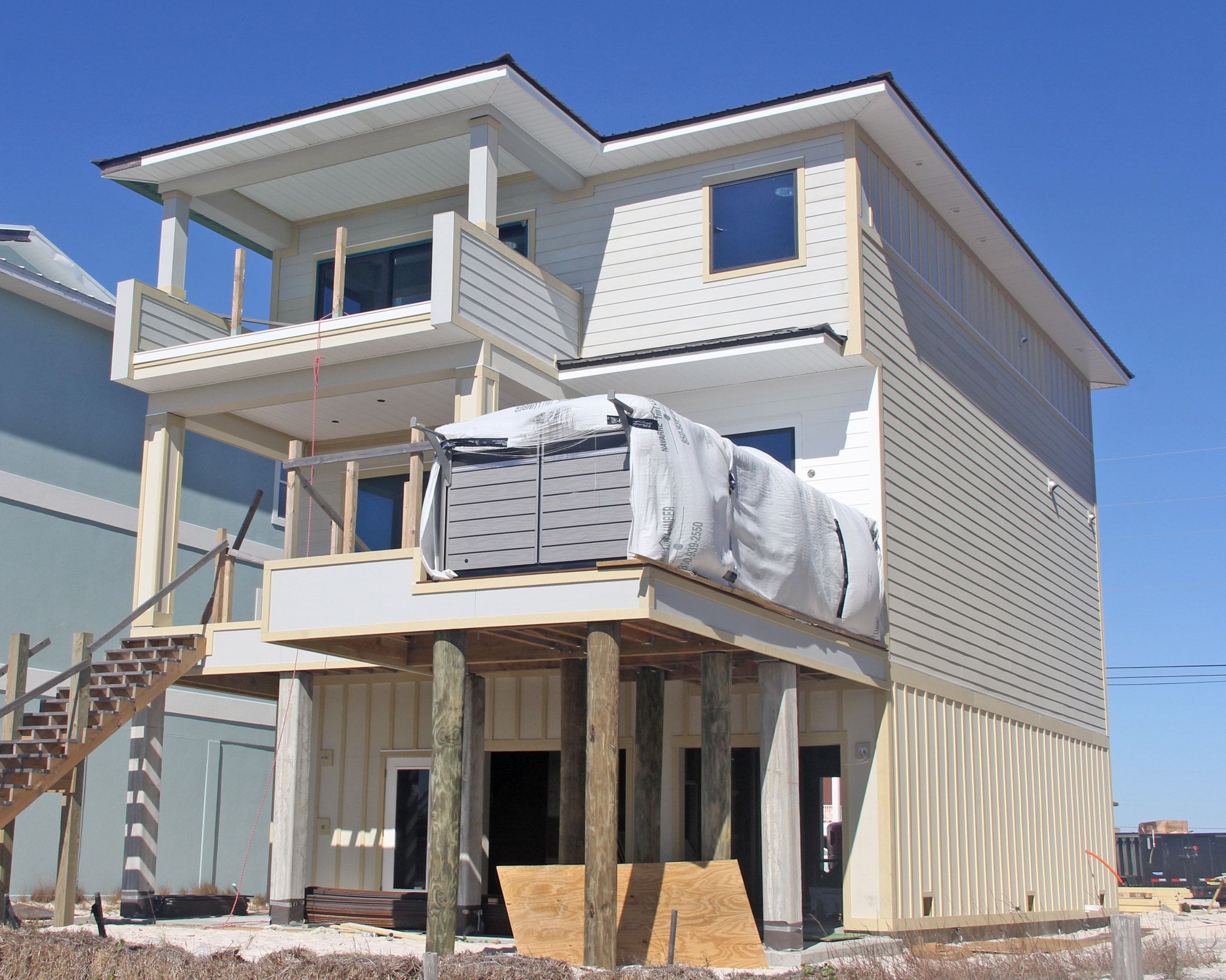 Davis modern coastal piling home on Navarre Beach by Acorn Fine Homes